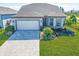 Stunning curb appeal with a paved driveway and well-manicured landscaping at 8705 Coastal Key Way, Parrish, FL 34219