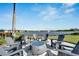 Outdoor fire pit with Adirondack chairs and lake view at 8705 Coastal Key Way, Parrish, FL 34219