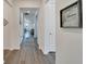 Bright hallway with wood-look flooring and views into the living room at 8705 Coastal Key Way, Parrish, FL 34219