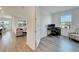 Home office with wood-look floors and a view of living area at 8705 Coastal Key Way, Parrish, FL 34219