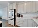 Sleek kitchen with white cabinets, stainless steel appliances and a built in fridge at 8705 Coastal Key Way, Parrish, FL 34219