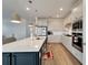 Bright kitchen with white cabinets, quartz countertops, and stainless steel appliances at 8705 Coastal Key Way, Parrish, FL 34219