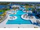 Expansive pool area with multiple pools, lounge chairs, and palm trees at 8705 Coastal Key Way, Parrish, FL 34219