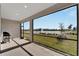 Screened-in patio with lake view and gas grill at 8705 Coastal Key Way, Parrish, FL 34219