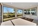 Relaxing screened patio with table and chairs, offering a view of the backyard at 8705 Coastal Key Way, Parrish, FL 34219