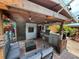 Covered patio with outdoor kitchen and seating at 8726 N Orange Pl, Tampa, FL 33617