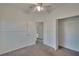 Bedroom with ceiling fan, door to bathroom, and spacious closet at 9622 Cypress Harbor Dr, Gibsonton, FL 33534