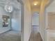 Hallway with carpet flooring and access to bedrooms and bathroom at 9622 Cypress Harbor Dr, Gibsonton, FL 33534