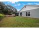 Home with large backyard, screened enclosure, and grassy area at 1009 Black Knight Dr, Valrico, FL 33594