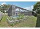 Expansive backyard with screened pool enclosure, offering ample space for recreation and relaxation at 1009 Black Knight Dr, Valrico, FL 33594