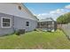 Large fenced backyard with a screened-in pool enclosure and green grass, perfect for outdoor activities at 1009 Black Knight Dr, Valrico, FL 33594