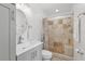Bathroom featuring a tiled shower, vanity with a round mirror, and a toilet at 1009 Black Knight Dr, Valrico, FL 33594