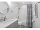 A full bathroom featuring marble tiling, a shower/bathtub combo, and gray vanity at 1009 Black Knight Dr, Valrico, FL 33594