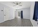 Bedroom with a ceiling fan, gray vinyl plank flooring, and a sliding door that leads to a pool at 1009 Black Knight Dr, Valrico, FL 33594