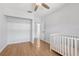Bedroom with a white crib, wood flooring, walk-in closet and light-colored walls at 1009 Black Knight Dr, Valrico, FL 33594