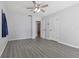 A bedroom with gray vinyl plank flooring and a ceiling fan at 1009 Black Knight Dr, Valrico, FL 33594