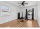 Bright workout area featuring wood floors, a ceiling fan and large windows at 1009 Black Knight Dr, Valrico, FL 33594
