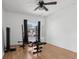 Bright exercise room featuring wood flooring, a ceiling fan and workout equipment at 1009 Black Knight Dr, Valrico, FL 33594