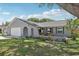 Charming single-story home features a manicured lawn, a gray exterior, and a two-car garage at 1009 Black Knight Dr, Valrico, FL 33594
