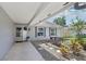 Charming covered porch with brick accents, a neutral-colored door, and flowering plants at 1009 Black Knight Dr, Valrico, FL 33594