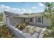A well-kept front yard is covered with rocks and low-lying ground cover along with shrubs at 1009 Black Knight Dr, Valrico, FL 33594