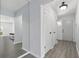 The hallway is painted a light blue with doors along the side of it and wood flooring at 1009 Black Knight Dr, Valrico, FL 33594
