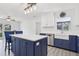 Open kitchen with an island, white countertops, navy cabinets, and stainless steel appliances at 1009 Black Knight Dr, Valrico, FL 33594