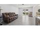 Bright living room with a brown leather sofa and a view to the outside at 1009 Black Knight Dr, Valrico, FL 33594