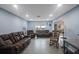 Relaxing living room featuring brown leather furniture and light blue walls at 1009 Black Knight Dr, Valrico, FL 33594