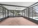 Bright sunroom with tile flooring, screened windows and a ceiling fan to create an inviting indoor-outdoor living space at 1009 Black Knight Dr, Valrico, FL 33594