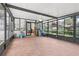 Bright sunroom with tile flooring, screened windows and a ceiling fan opening up into the main part of the home at 1009 Black Knight Dr, Valrico, FL 33594