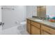 Bathroom with wood vanity, granite countertop, modern fixtures, and tiled shower at 12077 Gandy N Blvd # 332, St Petersburg, FL 33702