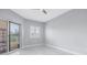 Bright bedroom with large window and sliding glass door to balcony and sleek, modern tile flooring at 12077 Gandy N Blvd # 332, St Petersburg, FL 33702