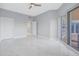 Spacious bedroom with sleek tile flooring, neutral walls, ceiling fan, and access to a private balcony at 12077 Gandy N Blvd # 332, St Petersburg, FL 33702