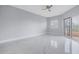 Bright bedroom with marble floors and access to a private balcony at 12077 Gandy N Blvd # 332, St Petersburg, FL 33702