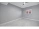 Bright bedroom with a ceiling fan, sleek tile flooring, neutral paint and plantation shutters at 12077 Gandy N Blvd # 332, St Petersburg, FL 33702