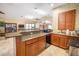 Kitchenette featuring wood cabinets, tile floors, granite countertops, and stainless steel appliances at 12077 Gandy N Blvd # 332, St Petersburg, FL 33702