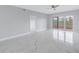 Bright and airy living room with marble floors and balcony access at 12077 Gandy N Blvd # 332, St Petersburg, FL 33702