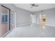 Bright, open living room featuring sleek tile floors and natural light from balcony doors at 12077 Gandy N Blvd # 332, St Petersburg, FL 33702