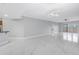 Spacious living area with access to kitchen, outside balcony, and modern lighting at 12077 Gandy N Blvd # 332, St Petersburg, FL 33702