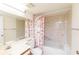 Clean bathroom with shower/tub combo and floral shower curtain at 12119 Sunny Glen Ln # F1, Hudson, FL 34669
