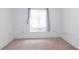 Empty bedroom with neutral carpeting and window coverings at 12119 Sunny Glen Ln # F1, Hudson, FL 34669