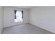 Simple bedroom featuring neutral carpeting and window coverings at 12119 Sunny Glen Ln # F1, Hudson, FL 34669