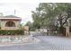 Gated community entrance with a charming guardhouse and brick pavers at 12119 Sunny Glen Ln # F1, Hudson, FL 34669