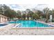 Inviting community pool with plenty of lounge chairs and a spa at 12119 Sunny Glen Ln # F1, Hudson, FL 34669