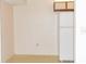 Small kitchen with white appliances and wood cabinets at 12119 Sunny Glen Ln # F1, Hudson, FL 34669