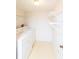 Laundry room with washer, dryer, and overhead shelving at 12119 Sunny Glen Ln # F1, Hudson, FL 34669