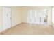 Living room with neutral walls, carpet, and sliding glass doors at 12119 Sunny Glen Ln # F1, Hudson, FL 34669