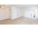 Bright living room featuring carpet flooring and sliding glass doors at 12119 Sunny Glen Ln # F1, Hudson, FL 34669