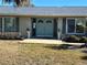 Close-up view of the teal front door with sidelights at 1401 Gulf Blvd, Belleair Beach, FL 33786